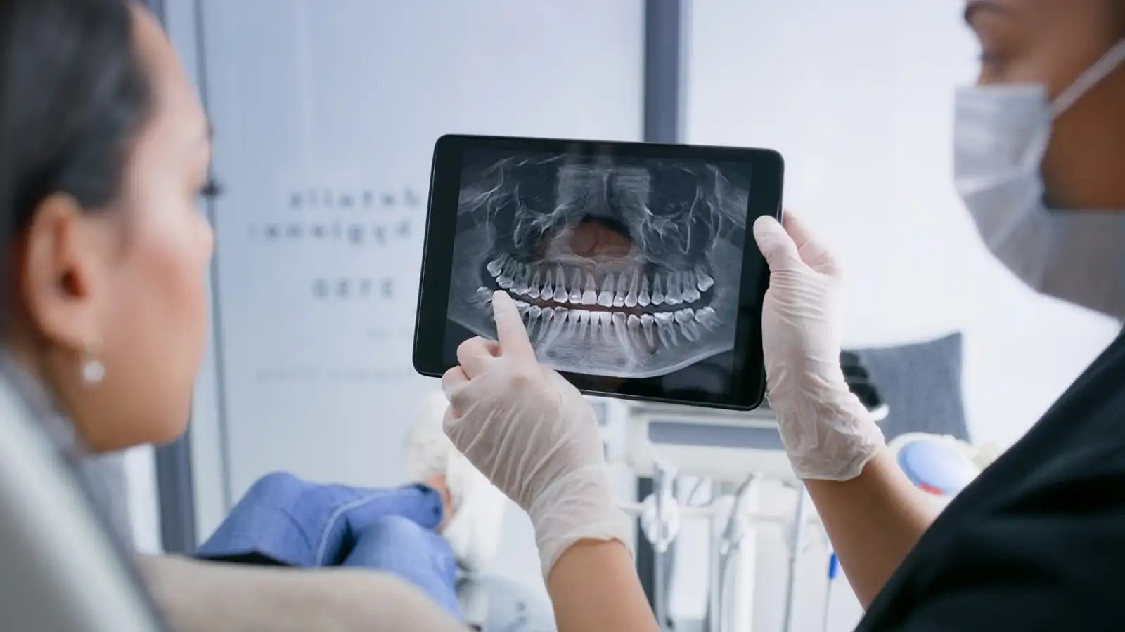 Dentist reviewing digital dental X-rays with a patient